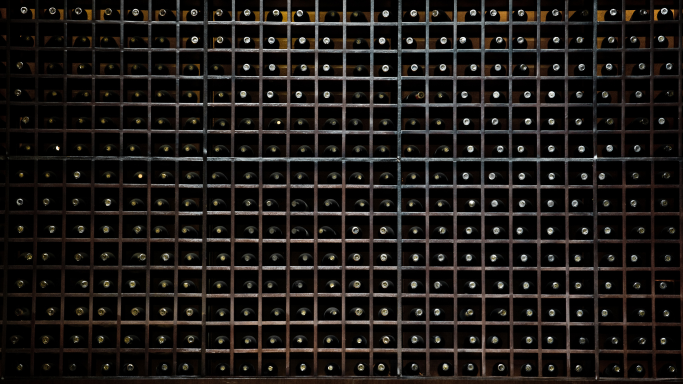 dark managed wine cellar in Singapore with climate-controlled racks for fine wine storage
